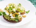 ndwich with avocado puree, boiled eggs and sandwich cream cheese, kiwi, nuts. Royalty Free Stock Photo