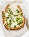 Vegetarian broccoli mozzarella cheese pizza on a light background, top view Royalty Free Stock Photo