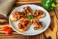 Vegetarian Bruschetta with tomatoes obasilic and olive on white plate close up Royalty Free Stock Photo