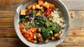 Vegetarian buddha bowl with quinoa, sweet potatoes, tofu, and fresh vegetables Royalty Free Stock Photo