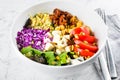 Vegetarian buddha bowl. Raw vegetables, tofu and bulgur in white bowl. Vegetarian, healthy detox food concept, close-up Royalty Free Stock Photo