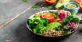 Vegetarian Buddha bowl of vegetables avocado, blood orange, broccoli, watermelon radish, spinach, quinoa, pumpkin seeds. Long Royalty Free Stock Photo