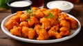 Vegetarian Buffalo Cauliflower Bites. Cauliflower buffalo wings with celery. AI Generative Royalty Free Stock Photo