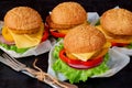 Vegetarian burgers with falafel, salad, onion, cheese and tomatoes on the black background. Traditional Middle Eastern fast food Royalty Free Stock Photo