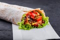 Vegetarian Burrito wraps from grilled vegetables and lettuce on dark wooden background Royalty Free Stock Photo