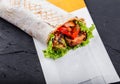 Vegetarian Burrito wraps from grilled vegetables and lettuce on dark wooden background Royalty Free Stock Photo