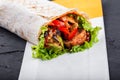 Vegetarian Burrito wraps from grilled vegetables and lettuce on dark wooden background Royalty Free Stock Photo