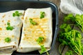 Vegetarian burritos wraps with beans, avocado and cheese on a slate