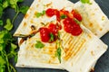 Vegetarian burritos wraps with beans, avocado and cheese on a slate