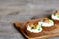 Vegetarian canape with soft cheese and mushrooms on a board on a wooden table Royalty Free Stock Photo