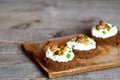 Vegetarian canape with soft cheese and mushrooms on a board on a wooden table Royalty Free Stock Photo