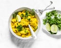 Vegetarian cauliflower cabbage curry sauce, cilantro, lime on light background, top view. Delicious indian food concept Royalty Free Stock Photo