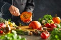 Vegetarian chef removing pips from a squash