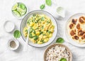 Vegetarian chickpea, spinach, potato curry, naan flatbread and wild rice on white background, top view. Indian healthy food