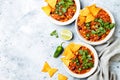 Vegetarian chili con carne with lentils, beans, nachos, lime, jalapeno. Mexican traditional dish. Royalty Free Stock Photo