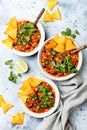 Vegetarian chili con carne with lentils, beans, nachos, lime, jalapeno. Mexican traditional dish. Royalty Free Stock Photo