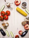 Vegetarian concept tomatoes, whole pepper, red bell pepper, corn, cucumbers and seasonings wooden rustic background top view cl