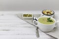 Vegetarian cream of broccoli, potato, onion, garlic, sesame and olive oil, and coconut milk .soup served in a white ceramic plate Royalty Free Stock Photo