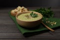 Vegetarian cream of broccoli, potato, onion, garlic, sesame and olive oil, and coconut milk soup. served in a white wooden plate Royalty Free Stock Photo