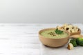 Vegetarian cream of broccoli, potato, onion, garlic, sesame and olive oil, and coconut milk soup. served in a white ceramic plate Royalty Free Stock Photo