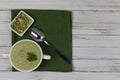 Vegetarian cream of broccoli, potato, onion, sesame and olive oil, and coconut milk. soup served in a white ceramic plate with a Royalty Free Stock Photo