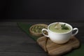 Vegetarian cream of broccoli, potatoes, onions, garlic, sesame and olive oil, and coconut milk soup served in a bowl with seeds on Royalty Free Stock Photo