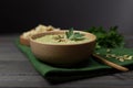 Vegetarian cream of broccoli, potatoes, onions, garlic, sesame and olive oil, and coconut milk soup served in a wooden bowl. on a Royalty Free Stock Photo