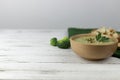 Vegetarian cream soup made of broccoli, potatoes, onions, garlic, sesame and olive oil, and coconut milk served in a wooden bowl. Royalty Free Stock Photo