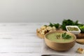 Vegetarian cream soup made of broccoli, potatoes, onions, garlic, sesame and olive oil, and coconut milk served in a wooden bowl. Royalty Free Stock Photo