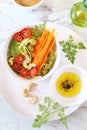 Vegetarian cuisine: salad of raw zucchini, carrot spaghetti, cherry tomatoes, olives