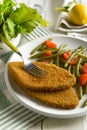 Vegetarian cutlet with green beans and tomato garnish