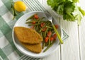 Vegetarian cutlet with green beans and tomato garnish