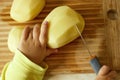 Vegetarian cuts vegetables for salad with a knife. Teaching your child how to safely handle a knife. Montessori trains