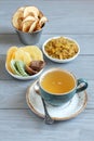 Vegetarian dessert: pieces of candied pineapple, mango and ginger root, dried figs, golden raisins, apple chips in small bowl Royalty Free Stock Photo