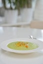 Vegetarian diet and vegan food, green healthy broccoli soup on a plate on a clean kitchen table. Tasty and nutritious meal, lunch Royalty Free Stock Photo