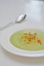 Vegetarian diet and vegan food, green healthy broccoli soup on a plate on a clean kitchen table. Tasty and nutritious meal, lunch Royalty Free Stock Photo