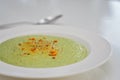 Vegetarian diet and vegan food, green healthy broccoli soup on a plate on a clean kitchen table. Tasty and nutritious meal, lunch Royalty Free Stock Photo