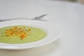 Vegetarian diet and vegan food, green healthy broccoli soup on a plate on a clean kitchen table. Tasty and nutritious meal, lunch Royalty Free Stock Photo