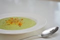 Vegetarian diet and vegan food, green healthy broccoli soup on a plate on a clean kitchen table. Tasty and nutritious meal, lunch Royalty Free Stock Photo