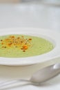 Vegetarian diet and vegan food, green healthy broccoli soup on a plate on a clean kitchen table. Tasty and nutritious meal, lunch Royalty Free Stock Photo