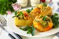 Peppers stuffed with quinoa, shrimp and vegetables on white wooden table Royalty Free Stock Photo