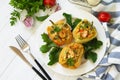 Peppers stuffed with quinoa, shrimp and vegetables on white wooden table Royalty Free Stock Photo