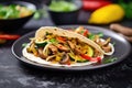 vegetarian fajitas with mushrooms and zucchini on a slate surface Royalty Free Stock Photo