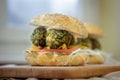 Vegetarian fast food - falafel burger on wooden board.