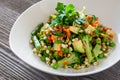 Vegetarian food: Beautiful delicious salad with avocado, broccoli, carrot, green peas, green beans with sprouted seeds.