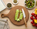 Vegetarian food. Chopping cucumber, cutting vegetables for greek salad horiatiki. Royalty Free Stock Photo