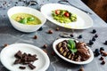 Vegetarian food, green cream soup, sala with asparagus and cherry tometoes, banana and vegan chocolate ice cream Royalty Free Stock Photo