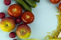 Vegetarian food, top shot of fruits, vegetables, cheese, pasta, legumes, mushrooms, forming a frame on a blue background