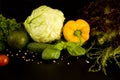 Vegetarian food. Yellow sweet bell pepper, cherry tomato and green vegetables on dark background. Royalty Free Stock Photo