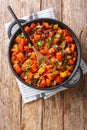 Vegetarian fried sweet potato black bean chili with tomatoes close-up in a pan. Vertical top view Royalty Free Stock Photo